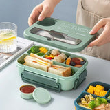 Student and office worker-friendly compartmentalized lunch box with fork and spoon, suitable for microwave use